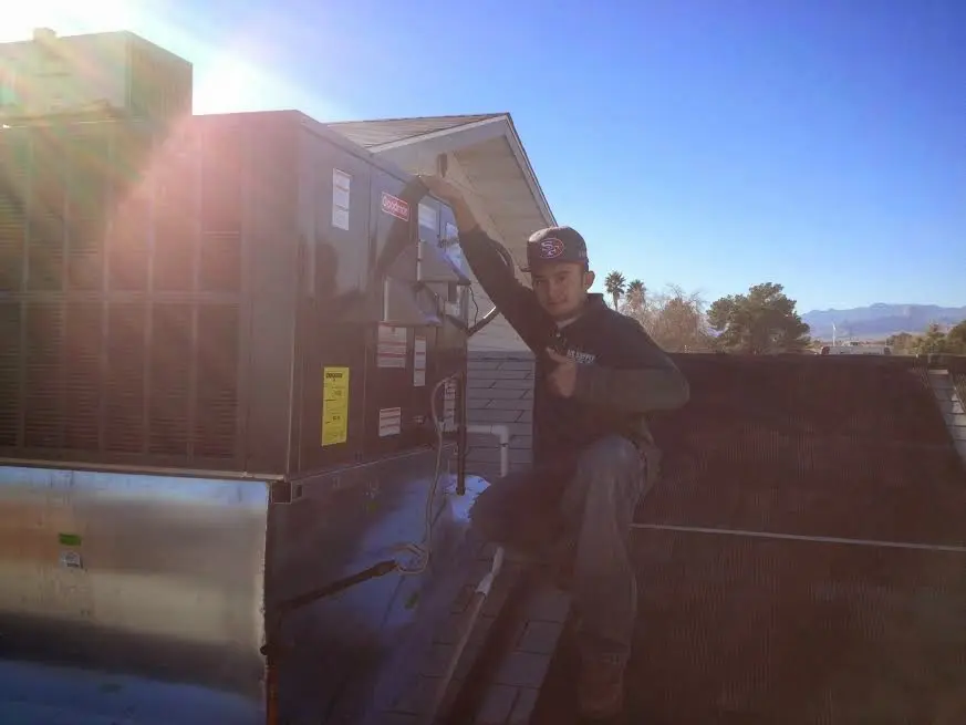 HVAC technician performing AC Tune-Up on a rooftop unit in Berkeley
